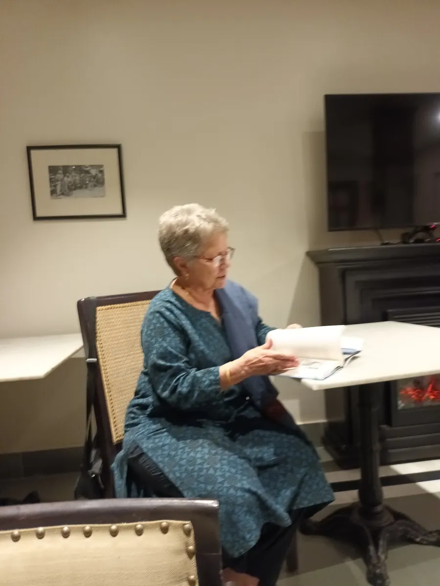 Joyce Burkhalter Flueckiger reading from her book in a sitting room