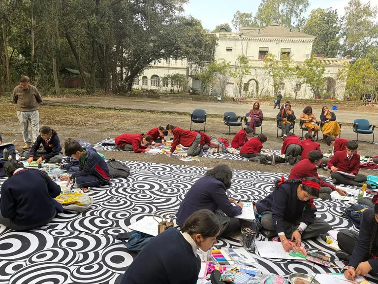Students painting on the lawn in front of the old Rangers College building