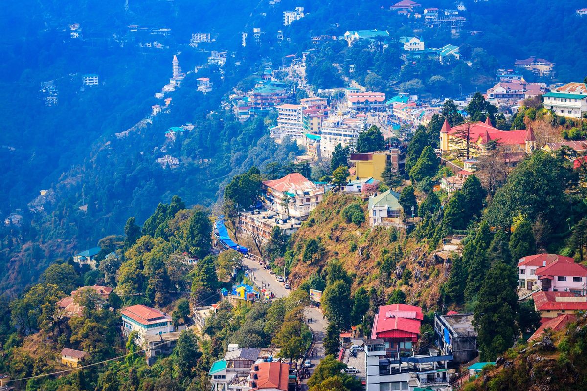 Mussoorie spread along its ridge above a forested valley