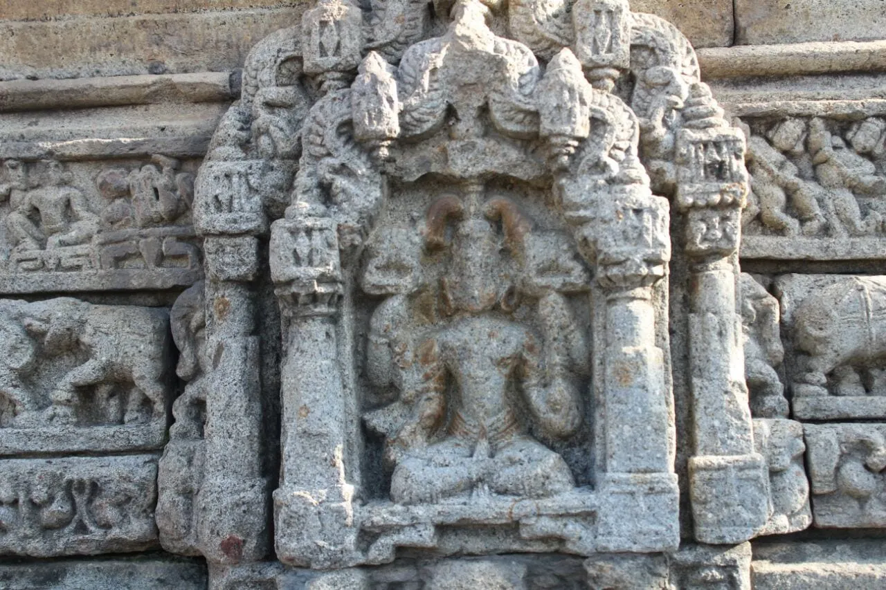 A carved stone panel of Shiva on the wall of the Baleshwar temple, Champawat