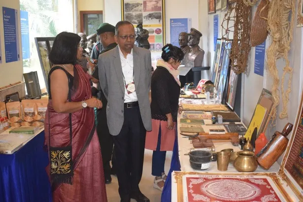 Visitors at the Uttarakhand Museum Community exhibition, among copper vessels and ringal baskets